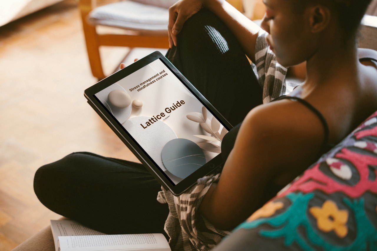 Person holding a tablet with a 'Lattice Guide' on the screen, sitting on a couch.