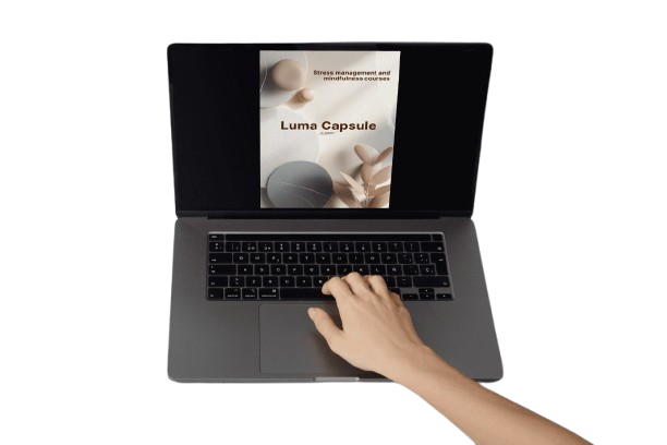 Person using a laptop with a screen displaying 'Luma Capsule' on a white background