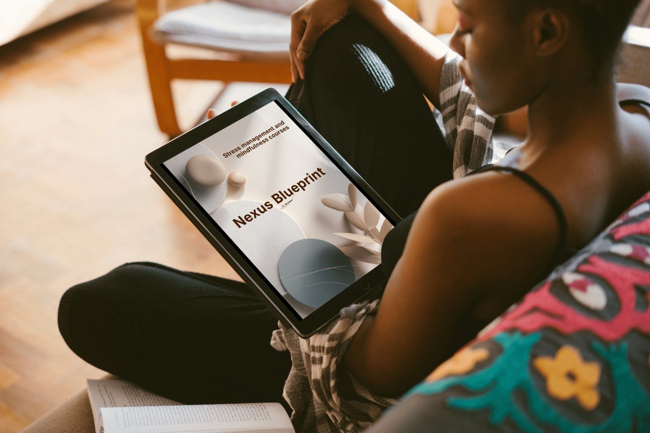 Person holding a tablet with 'Nexus Blueprint' displayed, sitting on a couch.